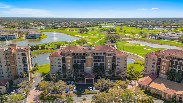 aerial view with golf course view and a water view