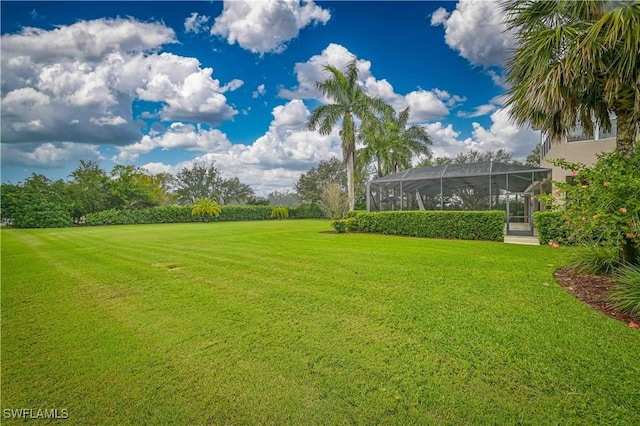 view of yard featuring a lanai