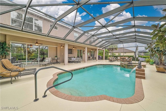 view of pool with an in ground hot tub, ceiling fan, a lanai, and a patio