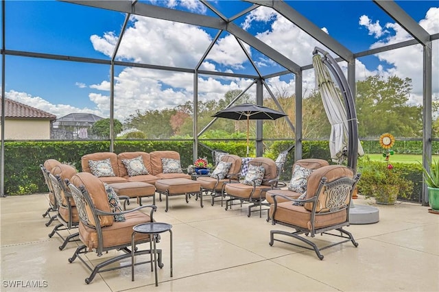 view of patio featuring an outdoor hangout area and glass enclosure