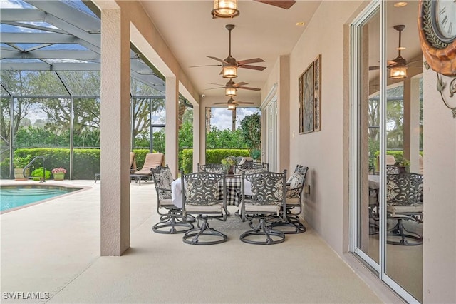 view of patio / terrace featuring a lanai and ceiling fan