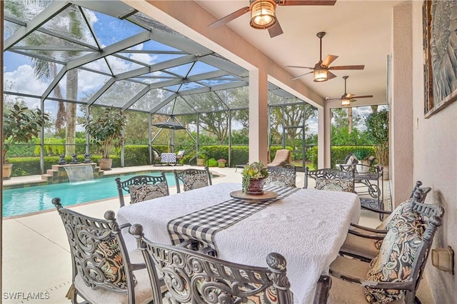 view of swimming pool featuring pool water feature, glass enclosure, and a patio area