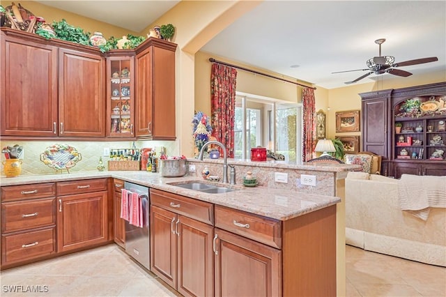 kitchen with dishwasher, sink, backsplash, light tile patterned floors, and kitchen peninsula