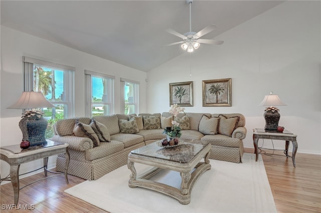 living room with ceiling fan, light hardwood / wood-style floors, and lofted ceiling