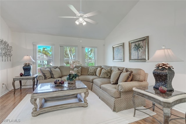 living room featuring ceiling fan, high vaulted ceiling, and light hardwood / wood-style floors