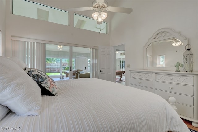 bedroom featuring access to exterior, a towering ceiling, and ceiling fan