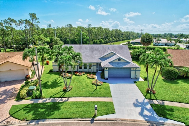 view of front of house featuring a garage and a front lawn