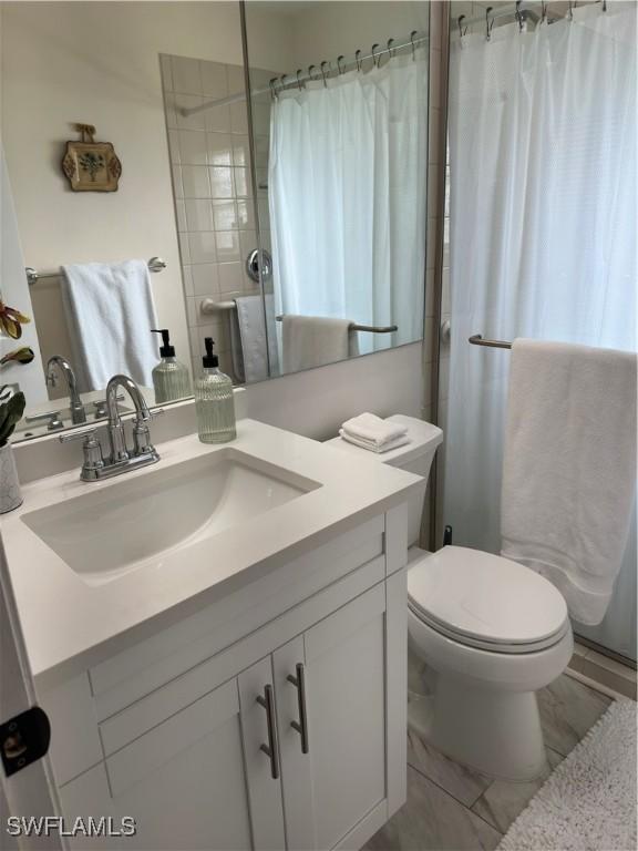 bathroom with vanity, toilet, and a shower with curtain