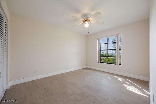 empty room with ceiling fan and light wood-type flooring