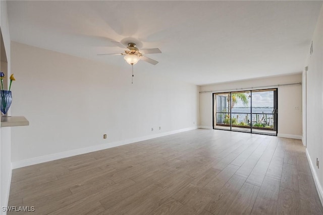 spare room with ceiling fan and light hardwood / wood-style floors