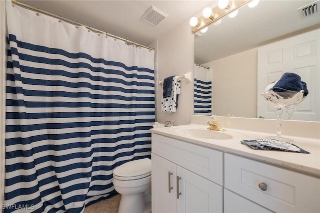 bathroom featuring tile patterned flooring, vanity, and toilet