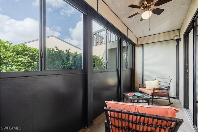 sunroom featuring ceiling fan