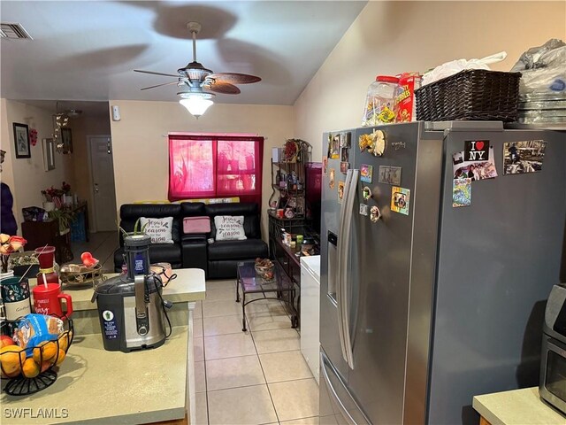 2205/2207 Armour Rd, Lehigh Acres, FL 33973 - kitchen featuring stainless steel refrigerator with ice dispenser, a ceiling fan, light tile patterned flooring, and light countertops