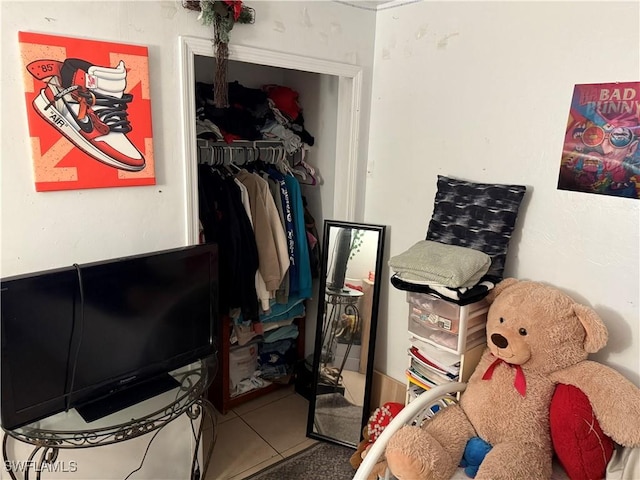 interior space with tile patterned floors and a closet