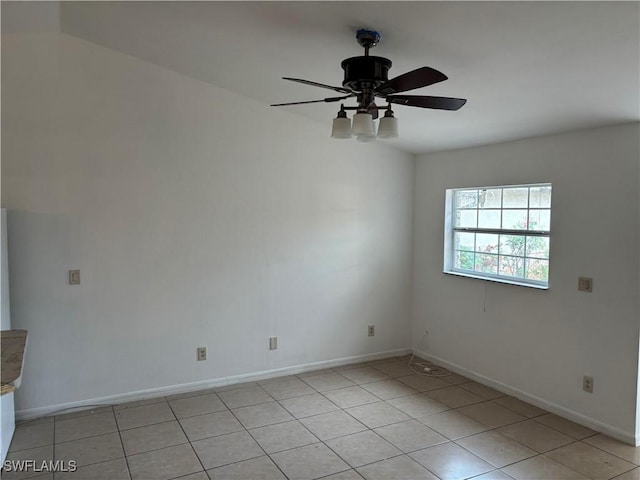 2205/2207 Armour Rd, Lehigh Acres, FL 33973 - empty room featuring light tile patterned floors, baseboards, and a ceiling fan
