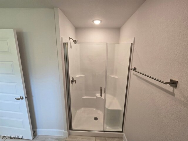 3102 E 2nd St, Lehigh Acres, FL 33936 - full bathroom featuring a shower stall and baseboards