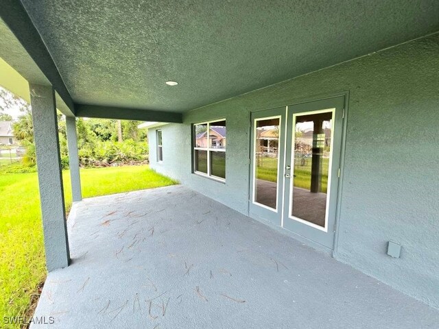3102 E 2nd St, Lehigh Acres, FL 33936 - view of patio with french doors
