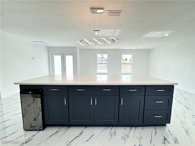 kitchen featuring pendant lighting, french doors, and a kitchen island