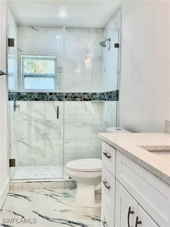 bathroom with vanity, an enclosed shower, and toilet