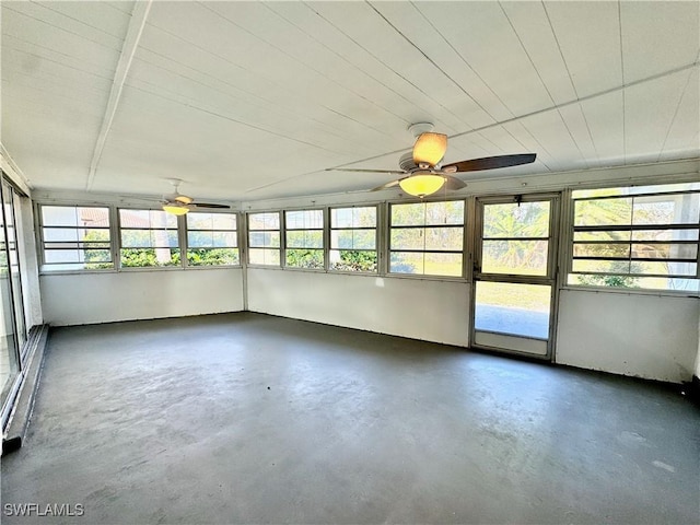 unfurnished sunroom with ceiling fan