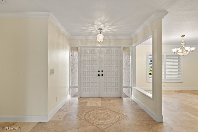 entryway featuring crown molding and an inviting chandelier