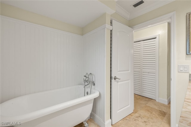 bathroom with a tub to relax in and crown molding