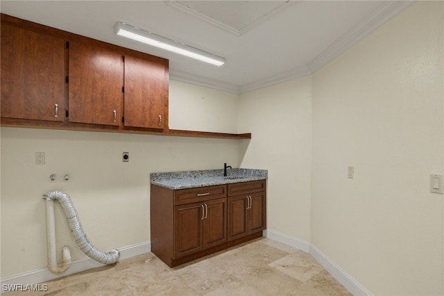 washroom featuring hookup for an electric dryer, cabinets, and ornamental molding