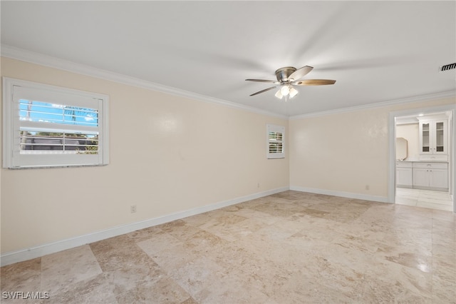 empty room featuring ceiling fan and crown molding