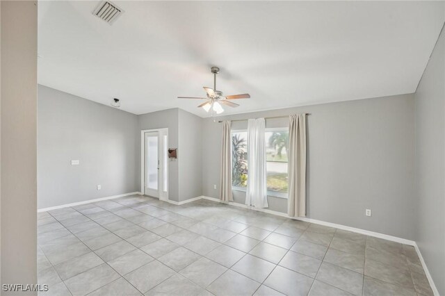 spare room with light tile patterned floors and ceiling fan