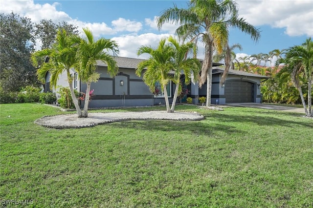 single story home with a garage and a front yard