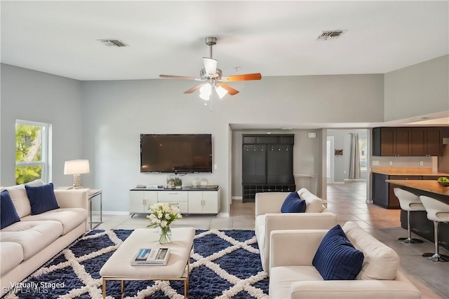 tiled living room with ceiling fan