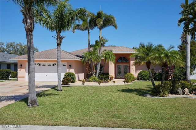 single story home with an attached garage, stucco siding, concrete driveway, a front lawn, and french doors