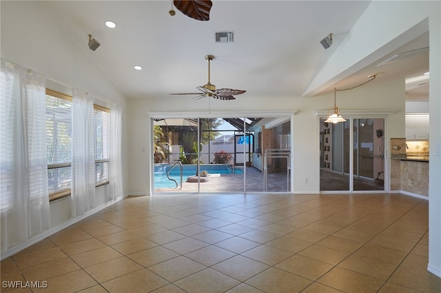 tiled spare room with visible vents, recessed lighting, a sunroom, ceiling fan, and vaulted ceiling