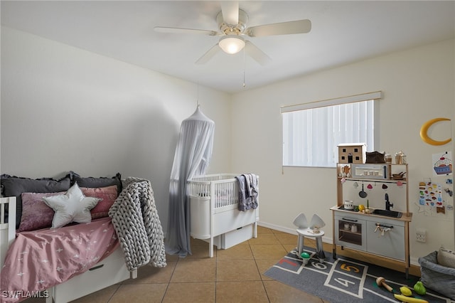 bedroom with tile patterned floors, baseboards, and a ceiling fan