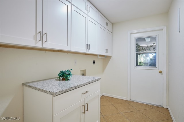 laundry room featuring cabinet space, light tile patterned floors, baseboards, hookup for an electric dryer, and hookup for a washing machine