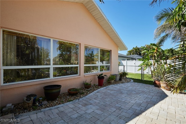 view of patio featuring a gate and fence