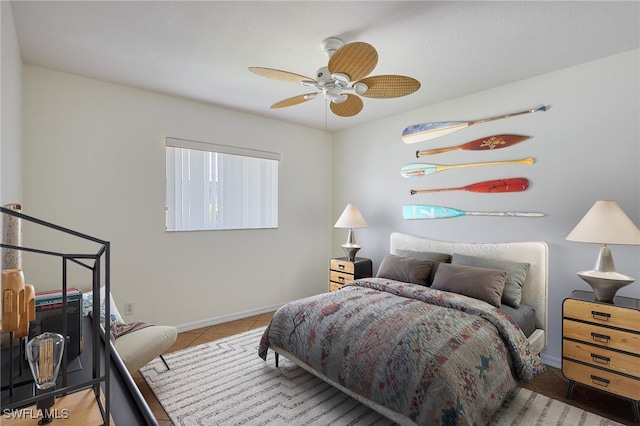 bedroom featuring baseboards, ceiling fan, and tile patterned flooring