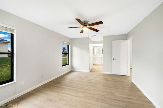 unfurnished room with light wood-type flooring and ceiling fan