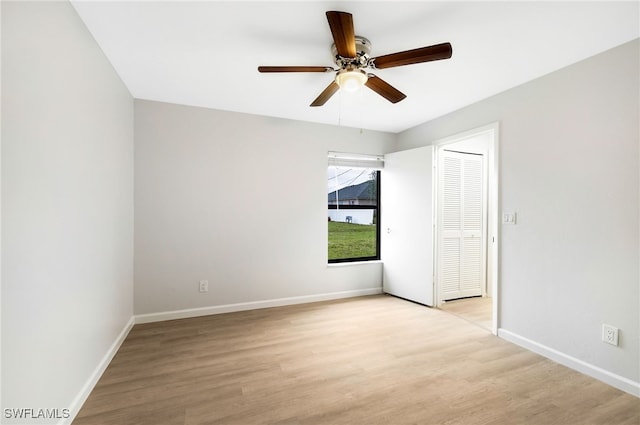 spare room with light hardwood / wood-style floors and ceiling fan