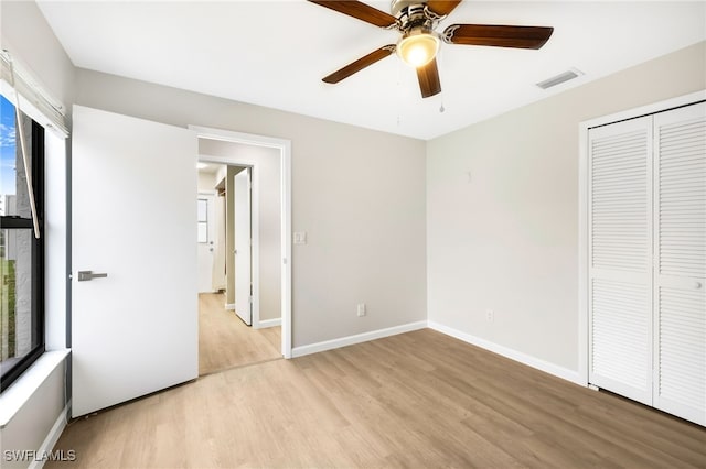 unfurnished bedroom with a closet, ceiling fan, and light hardwood / wood-style flooring