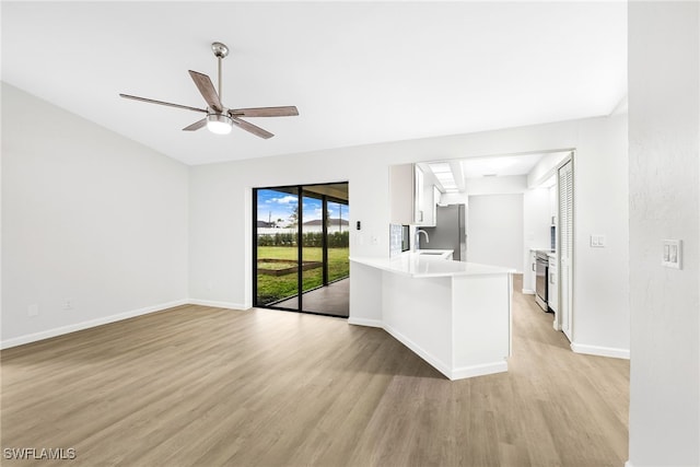 interior space featuring sink, light wood-type flooring, and ceiling fan