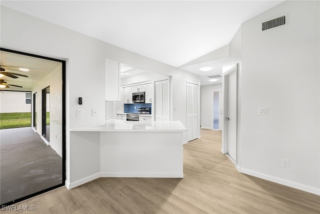 kitchen with appliances with stainless steel finishes, lofted ceiling, white cabinetry, kitchen peninsula, and ceiling fan