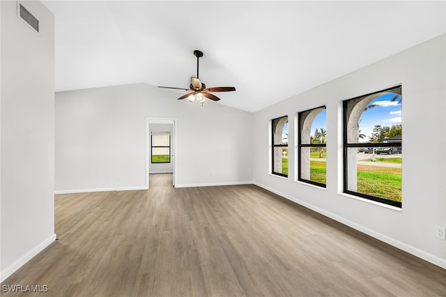 unfurnished living room with ceiling fan, lofted ceiling, and light wood-type flooring