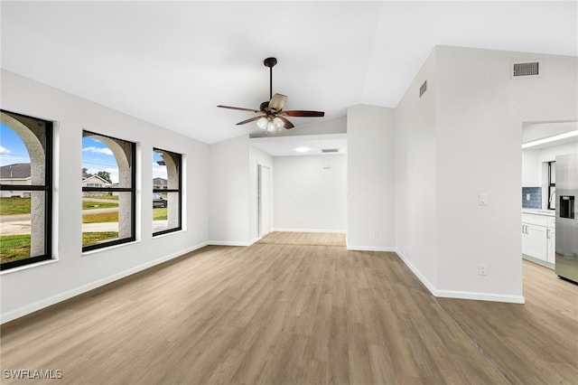 unfurnished living room featuring light hardwood / wood-style floors, vaulted ceiling, and ceiling fan