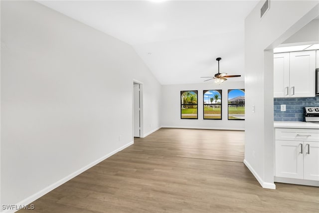 interior space with ceiling fan, light hardwood / wood-style floors, and lofted ceiling