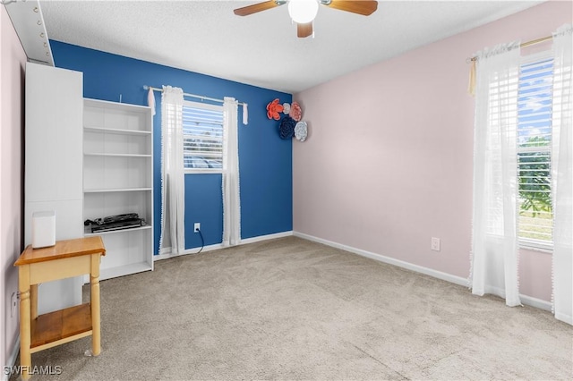 unfurnished bedroom featuring light colored carpet and ceiling fan