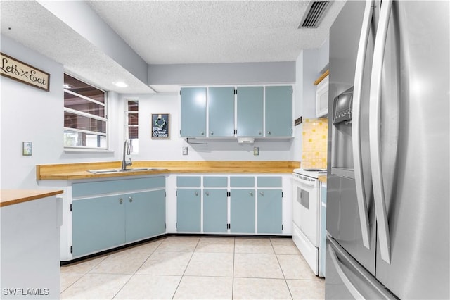 kitchen with electric stove, sink, wooden counters, a textured ceiling, and stainless steel fridge with ice dispenser