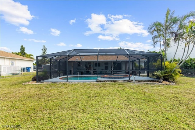 rear view of house featuring a lawn and glass enclosure