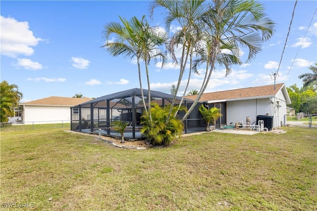 view of yard featuring a patio and a lanai