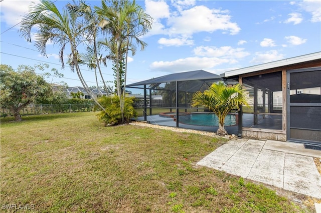 view of yard featuring a fenced in pool, a patio, a sunroom, and glass enclosure